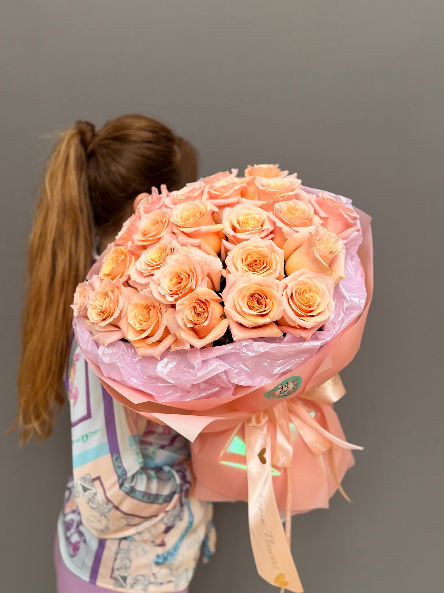 Side angle of an elegant peach rose arrangement with signature ribbon finish for same-day flower delivery in Northern Virginia and DC.