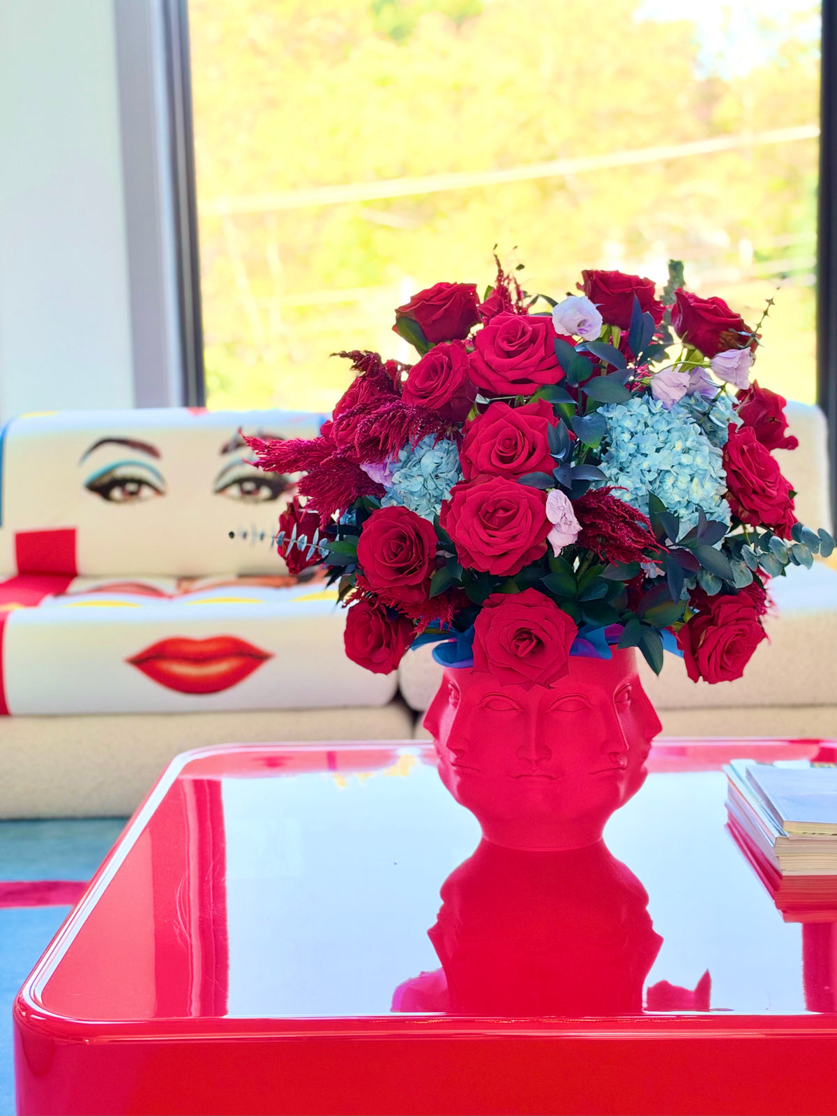 Modern red roses and blue hydrangea centerpiece in Face It 3D vase luxury floral delivery Potomac MD Bethesda McLean Washington DC⁠