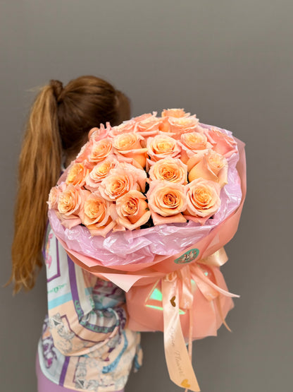 Side angle of an elegant peach rose arrangement with signature ribbon finish for same-day flower delivery in Northern Virginia and DC.
