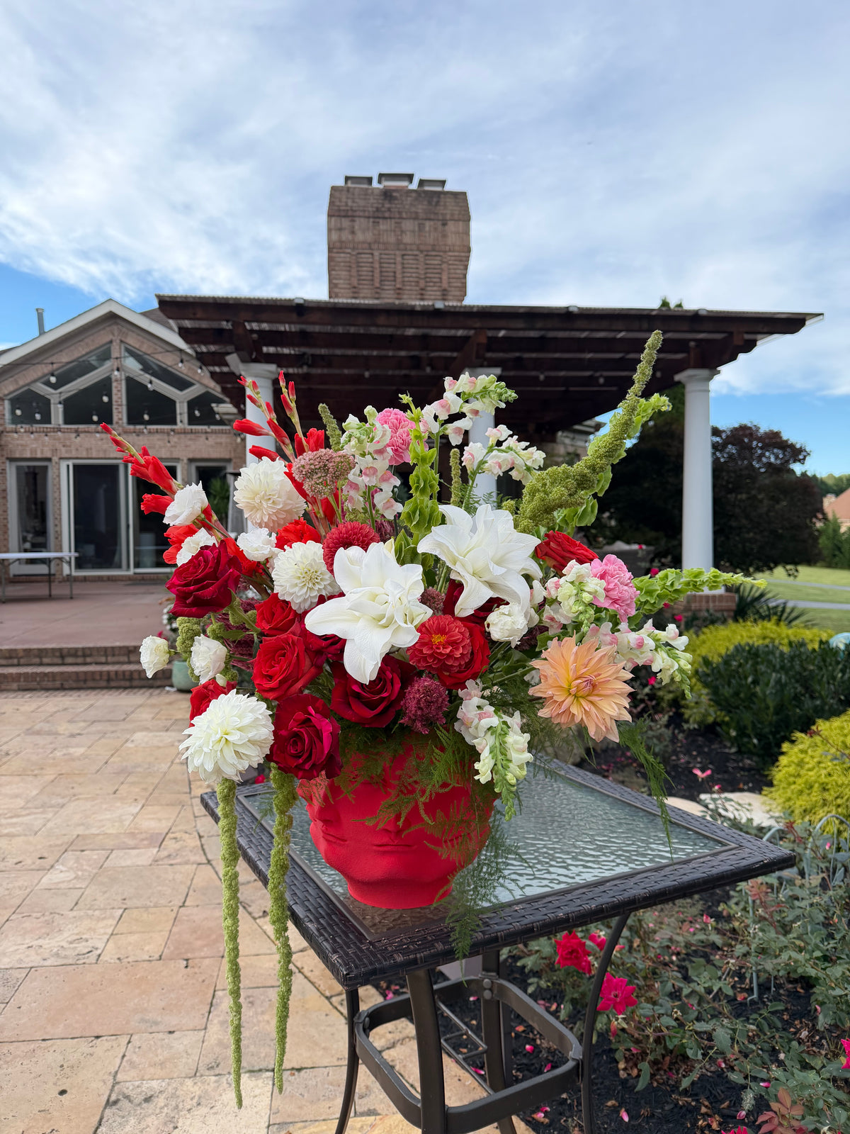 Face It Grand Opulence luxury dahlia and rose floral arrangement in red Face It sculpture vase outdoor delivery Potomac MD McLean VA Lapin Flowers⁠