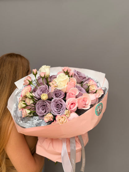 Premium luxury artisan bouquet with dusty lavender roses, blush pink roses, and pastel spray roses wrapped in peach and silver paper by Lapin Flowers. Upscale elite flower delivery for Bethesda Maryland and Washington DC.⁠