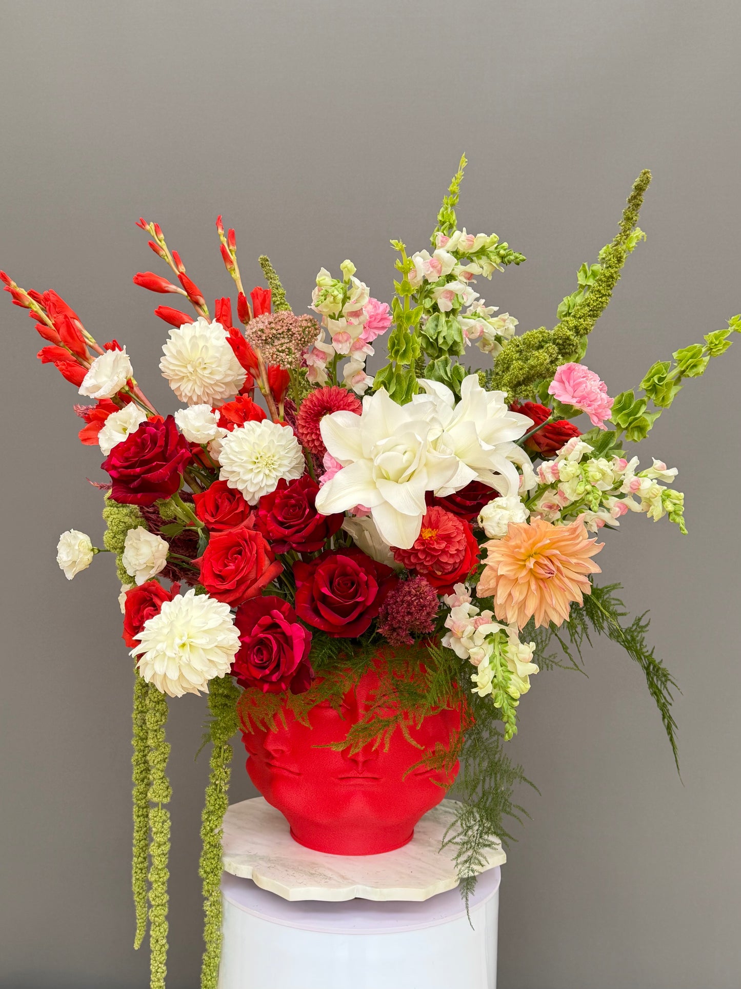 Large Dutch still life flower centerpiece in Face It 3D printed red bust vase luxury flower delivery Bethesda MD Washington DC Lapin Flowers⁠