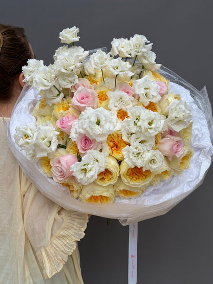 Close up of pastel pink roses and ruffled white lisianthus European spiral hand tied bouquet Lapin Flowers Highland MD Potomac⁠